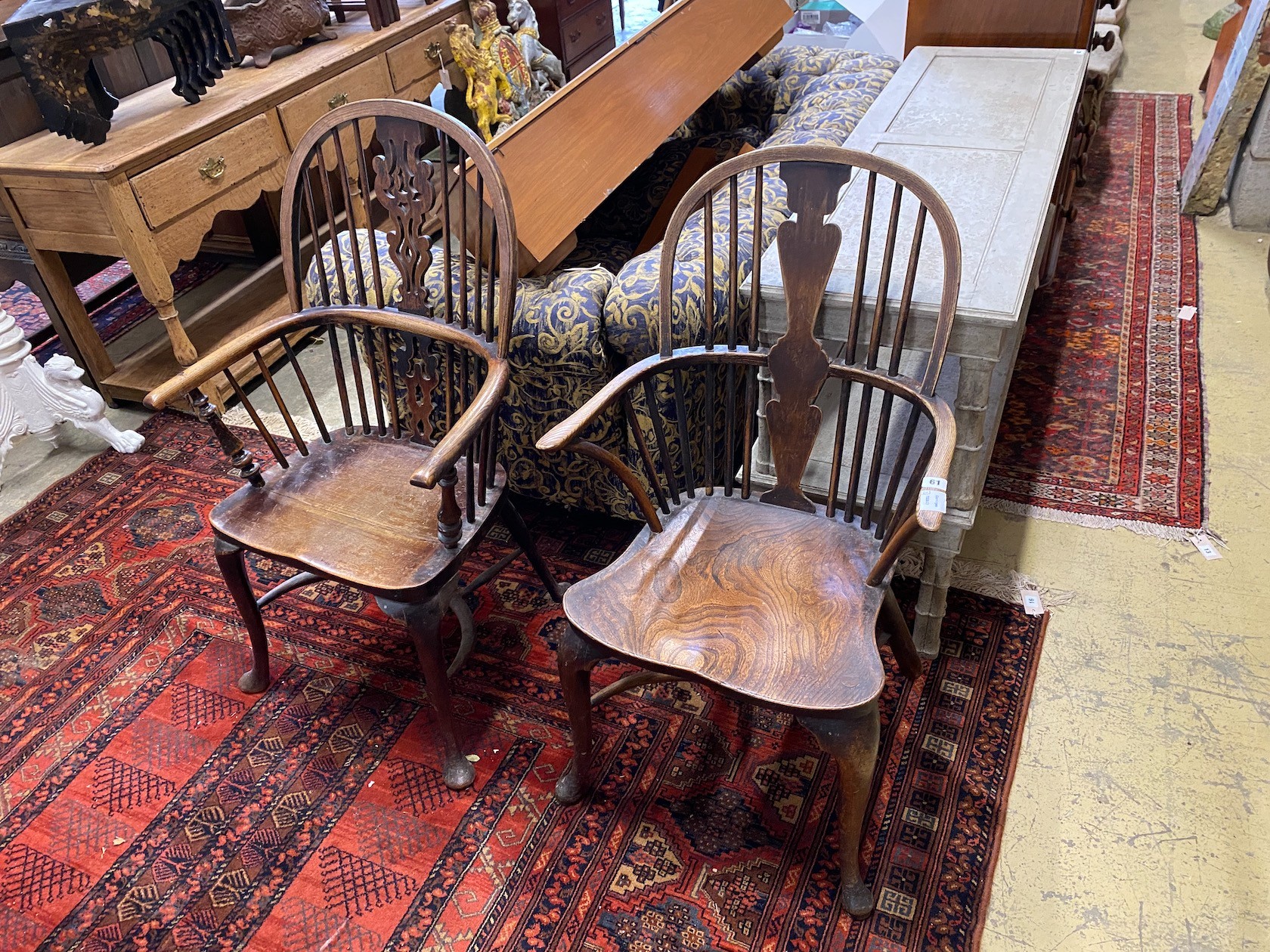 Two 19th century elm and ash Windsor elbow chairs, on front cabriole legs and crinoline stretchers, larger height 105cm